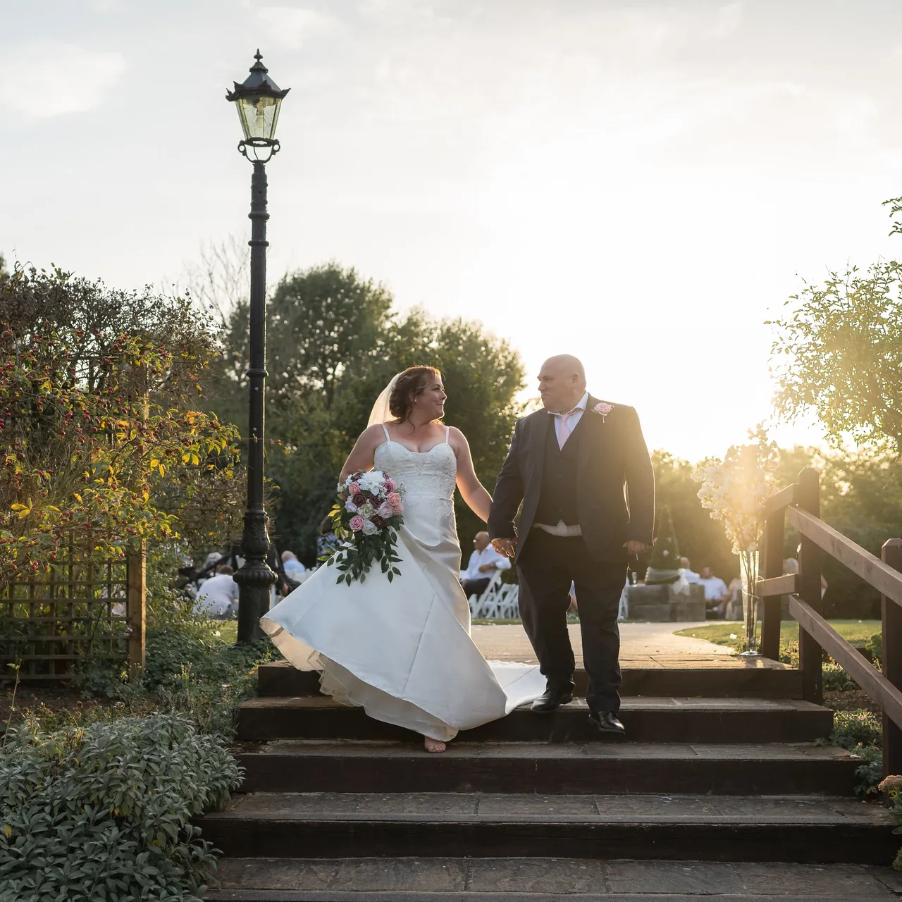 Bride and Groom walking down the steps of the garden