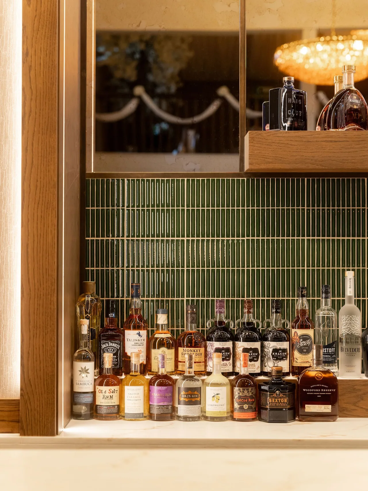 Spirit bottles lined along the bar shelf