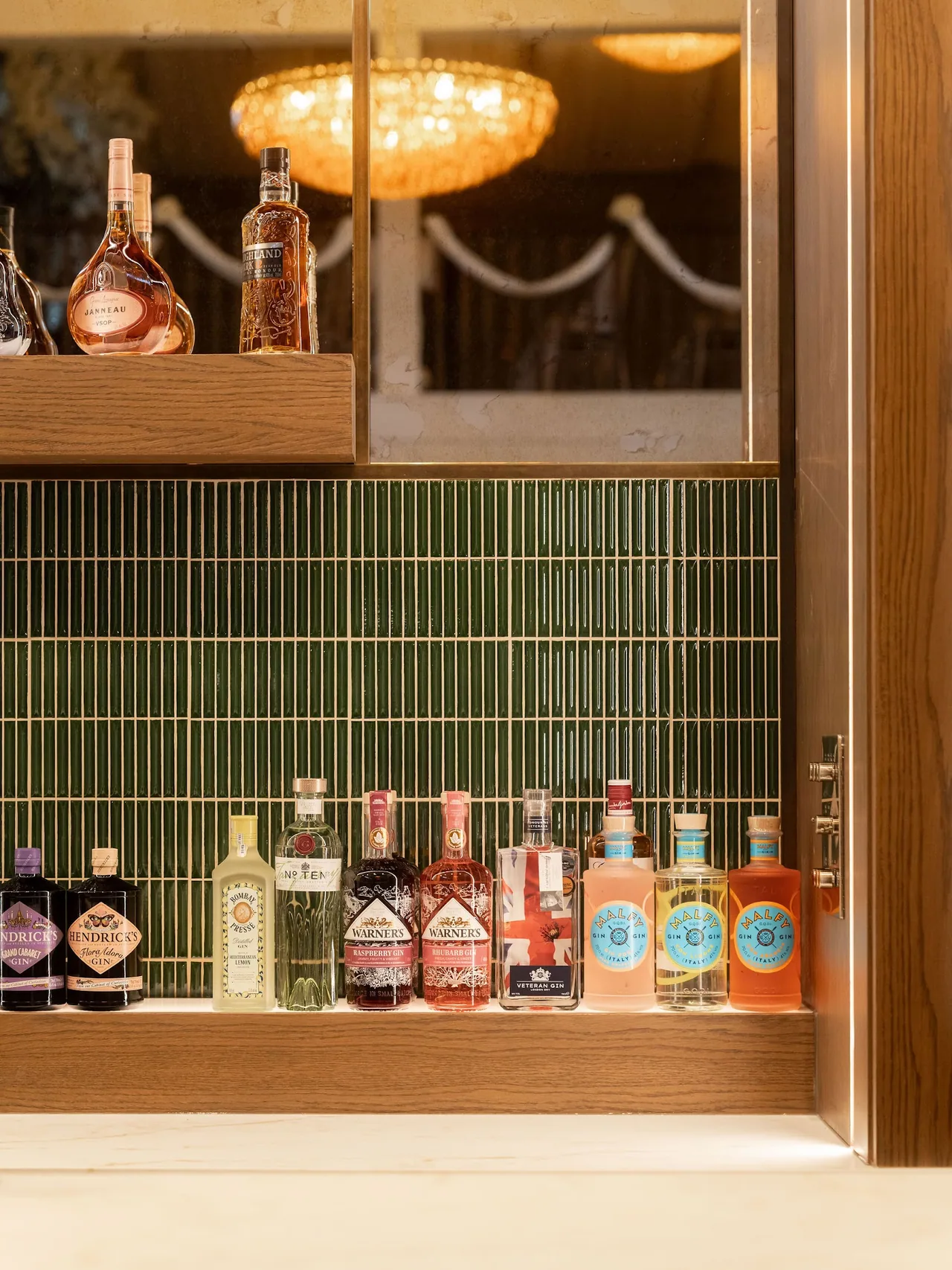 Bottles of gin and liqueur on the back bar