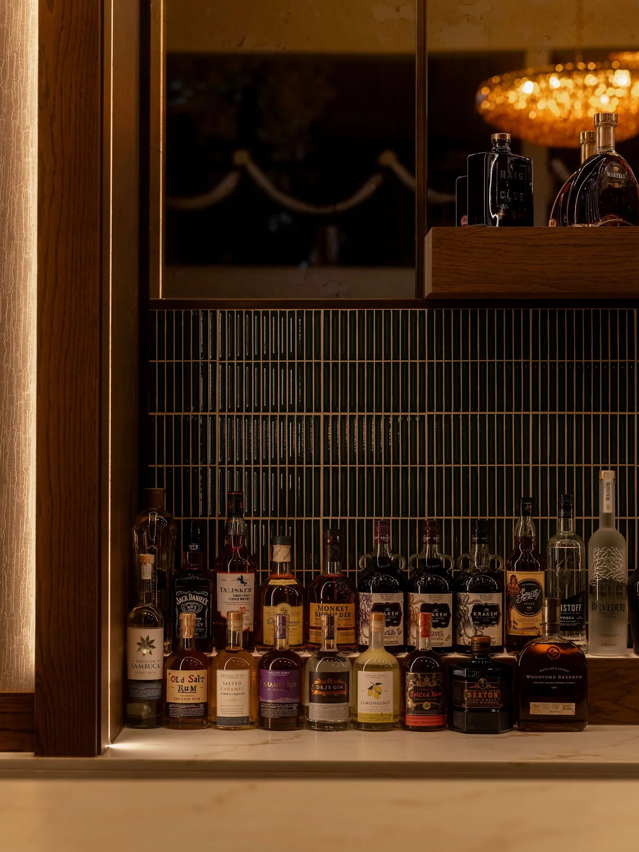 Backlit bottles behind the bar in the evening