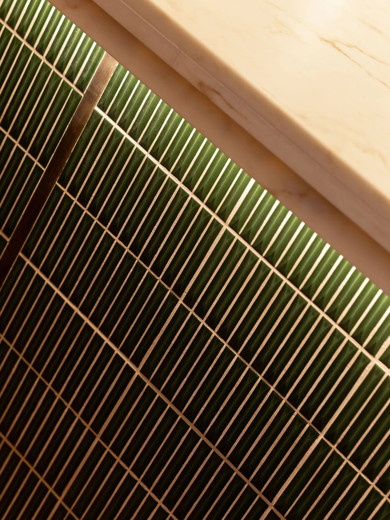 Deep green tiled bar front catching the light