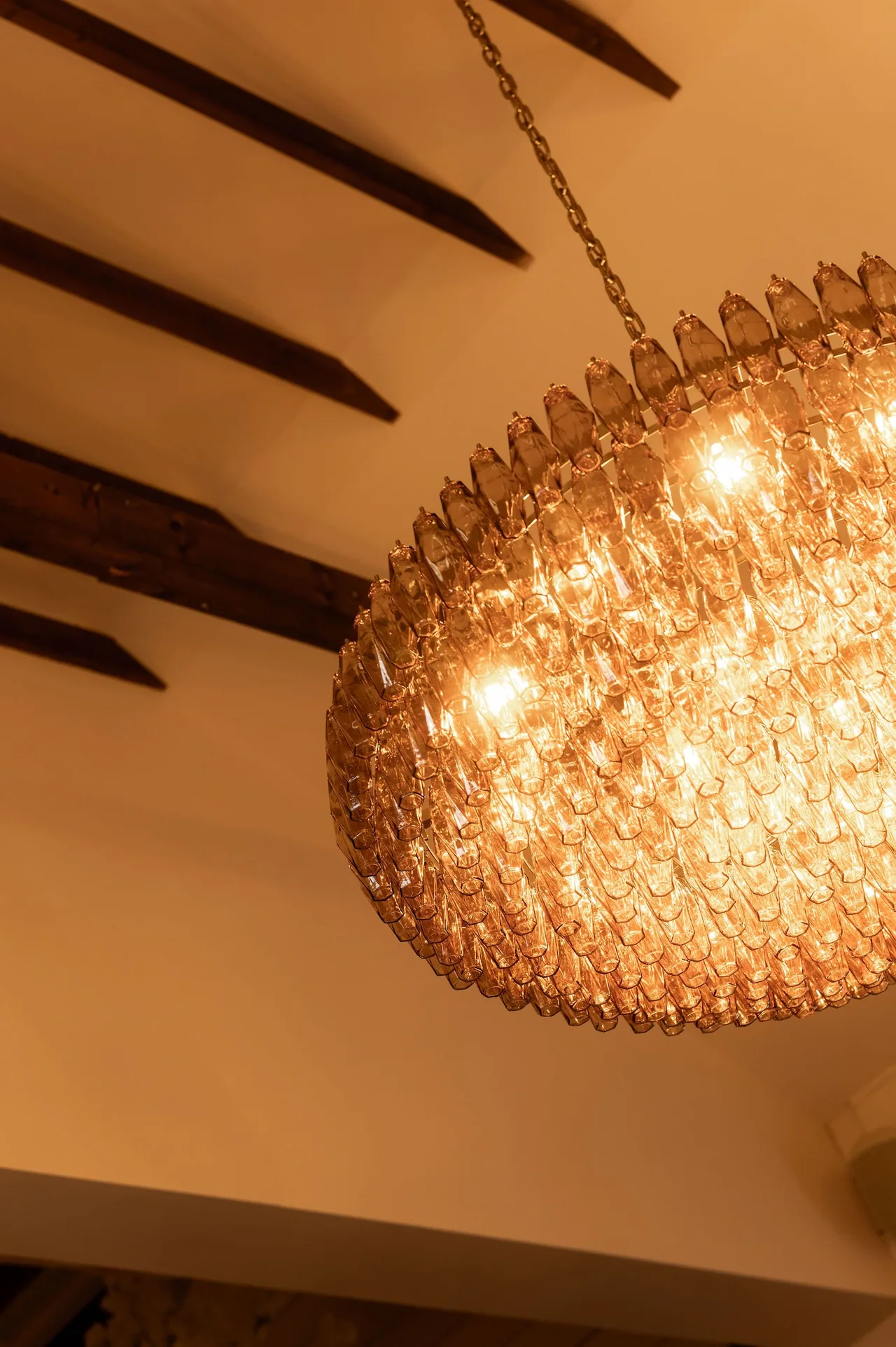 Warm light from the dining room chandelier